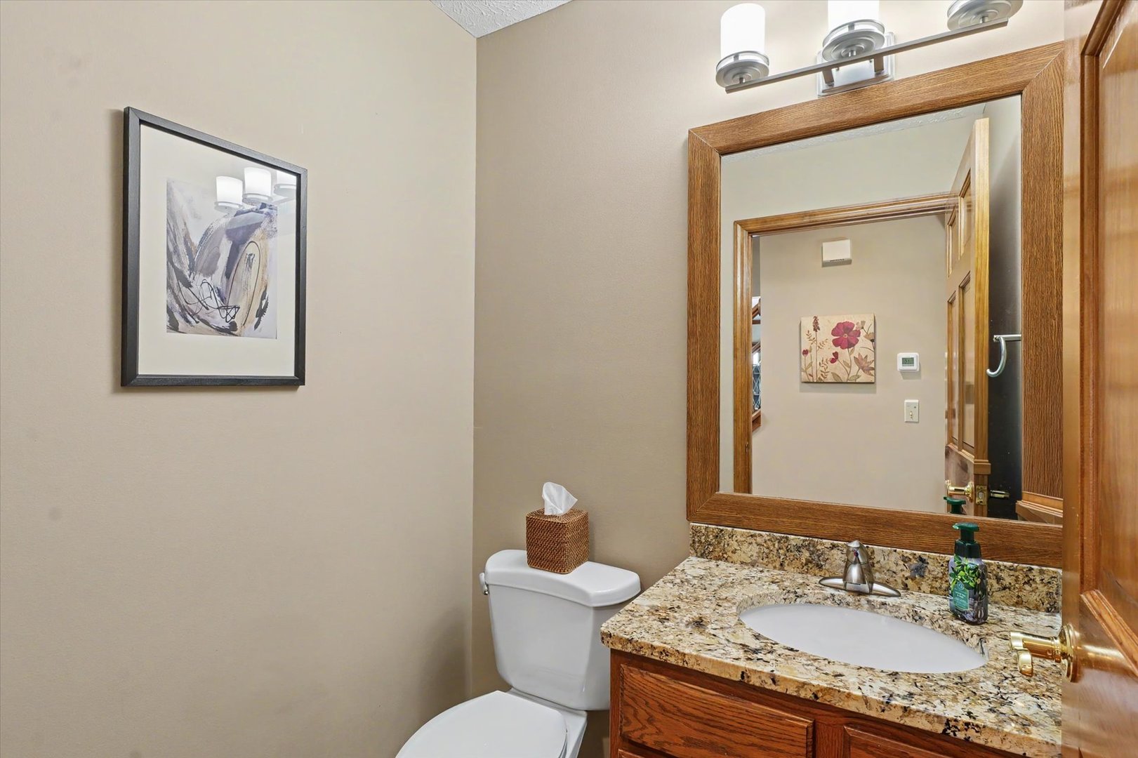 4409 Copper Ridge Road Champaign, IL 61822 - Photo 20 of 40 a bathroom with a granite countertop toilet a sink and mirror