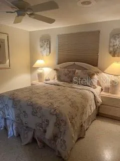 a bedroom with a bed and a night stand