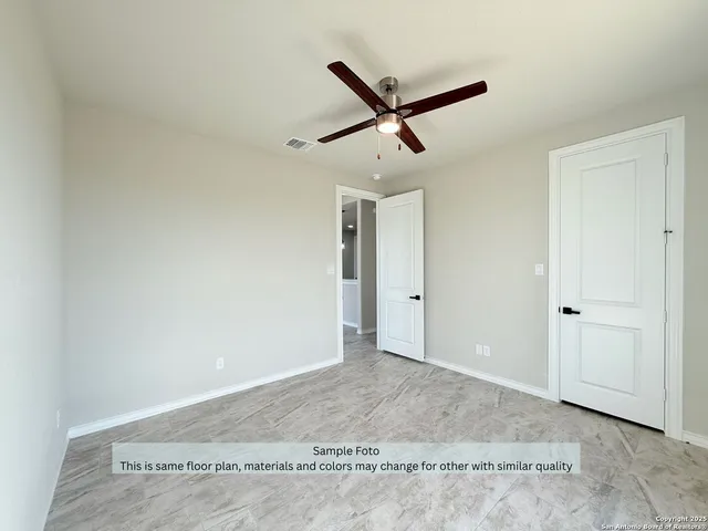 a view of a livingroom with a ceiling fan and window