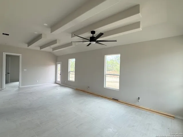 a view of a livingroom with a ceiling fan and window