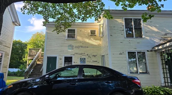 a side view of a house with a yard