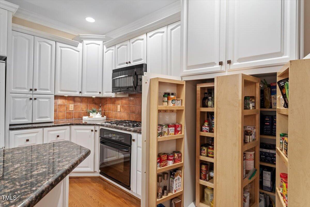 12329 Whartons Way Raleigh, NC 27613 - Photo 11 of 51 a kitchen with stainless steel appliances granite countertop a refrigerator and cabinets