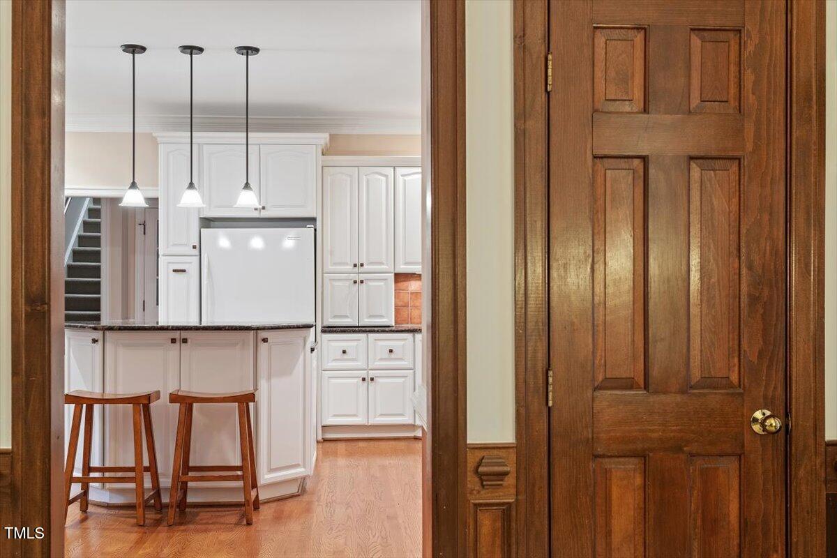 12329 Whartons Way Raleigh, NC 27613 - Photo 12 of 51 a view of cabinets and wooden floor