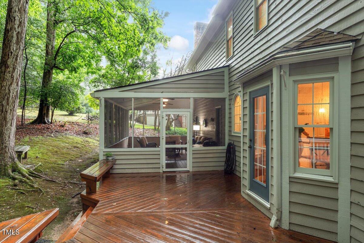 12329 Whartons Way Raleigh, NC 27613 - Photo 22 of 51 a view of a patio with table and chairs and wooden floor