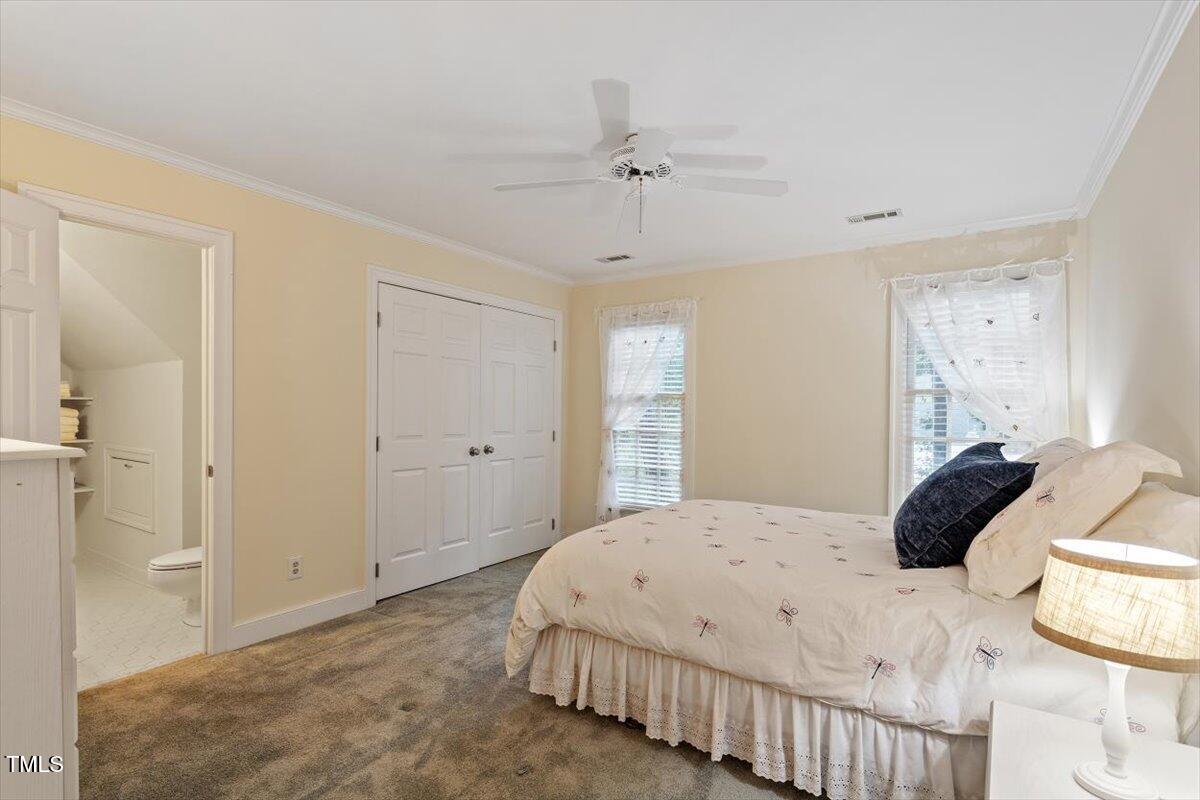 12329 Whartons Way Raleigh, NC 27613 - Photo 26 of 51 a bedroom with a bed and a chandelier