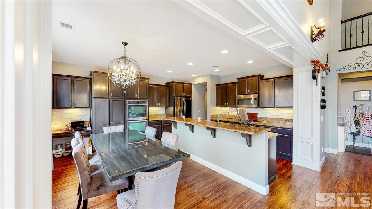 671 Caspian Court Reno, NV 89521 - Photo 12 of 33 a large kitchen with cabinets table and chairs