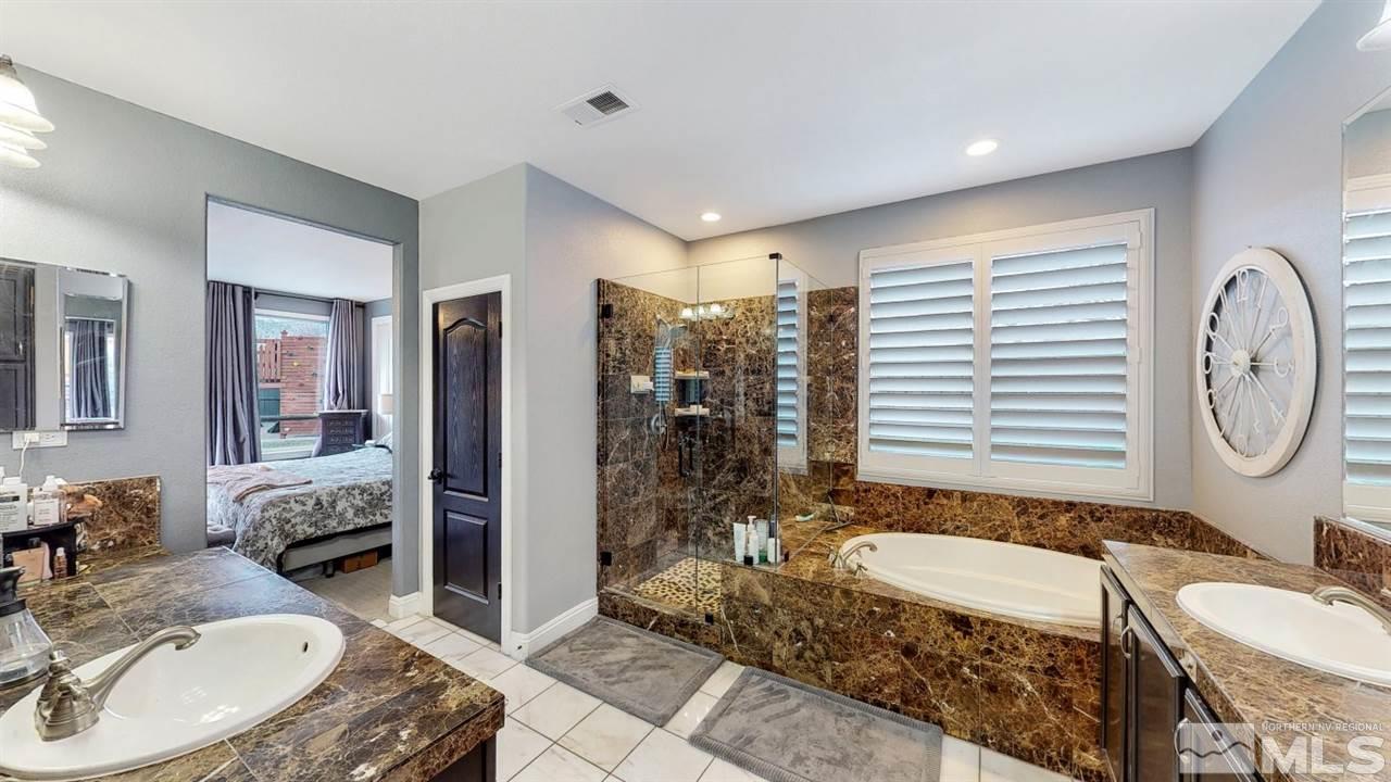 671 Caspian Court Reno, NV 89521 - Photo 29 of 33 a bathroom with a granite countertop sink and a mirror