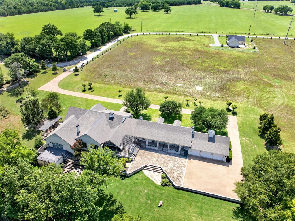 1901 Rose Pointe Athens, TX 75752 - Photo 27 of 37 Expansive property featuring a large residence with a multi-car garage, extensive paved and stone driveways, and mature landscaping