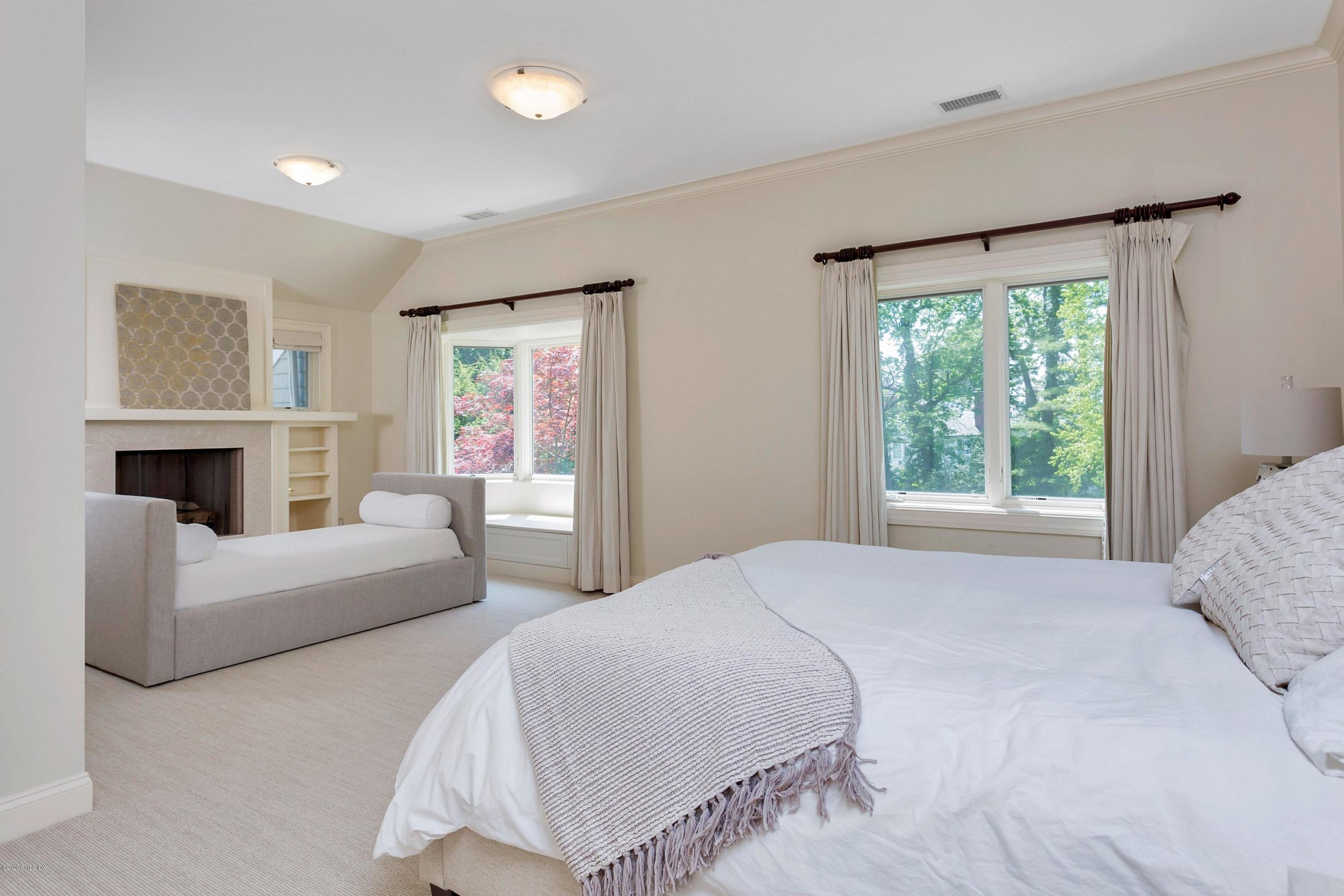 188 Otter Rock Drive Greenwich, CT 06830 - Photo 12 of 23 a spacious bedroom with a bed and a couch