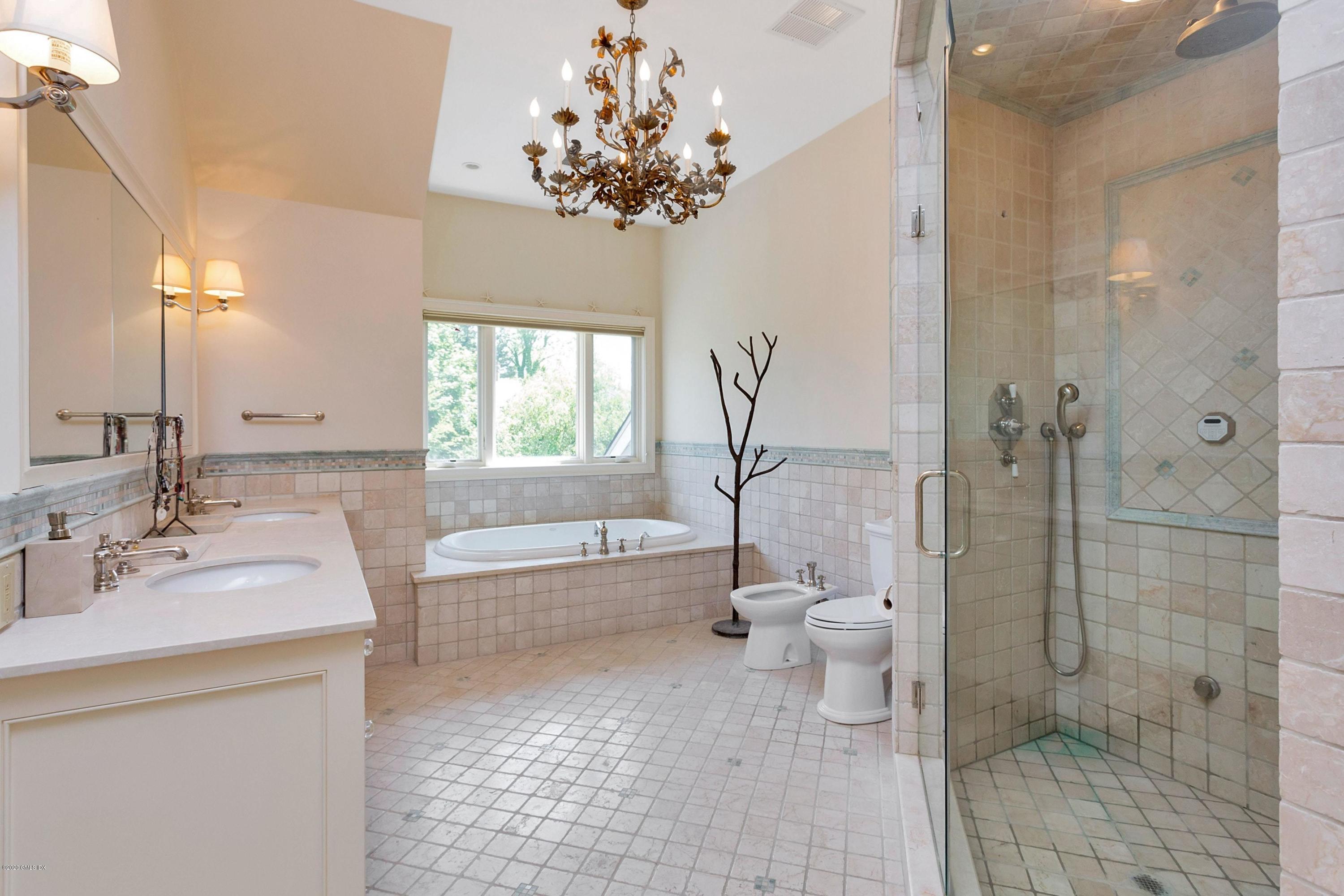 188 Otter Rock Drive Greenwich, CT 06830 - Photo 13 of 23 a bathroom with a granite countertop toilet a sink and a bathtub