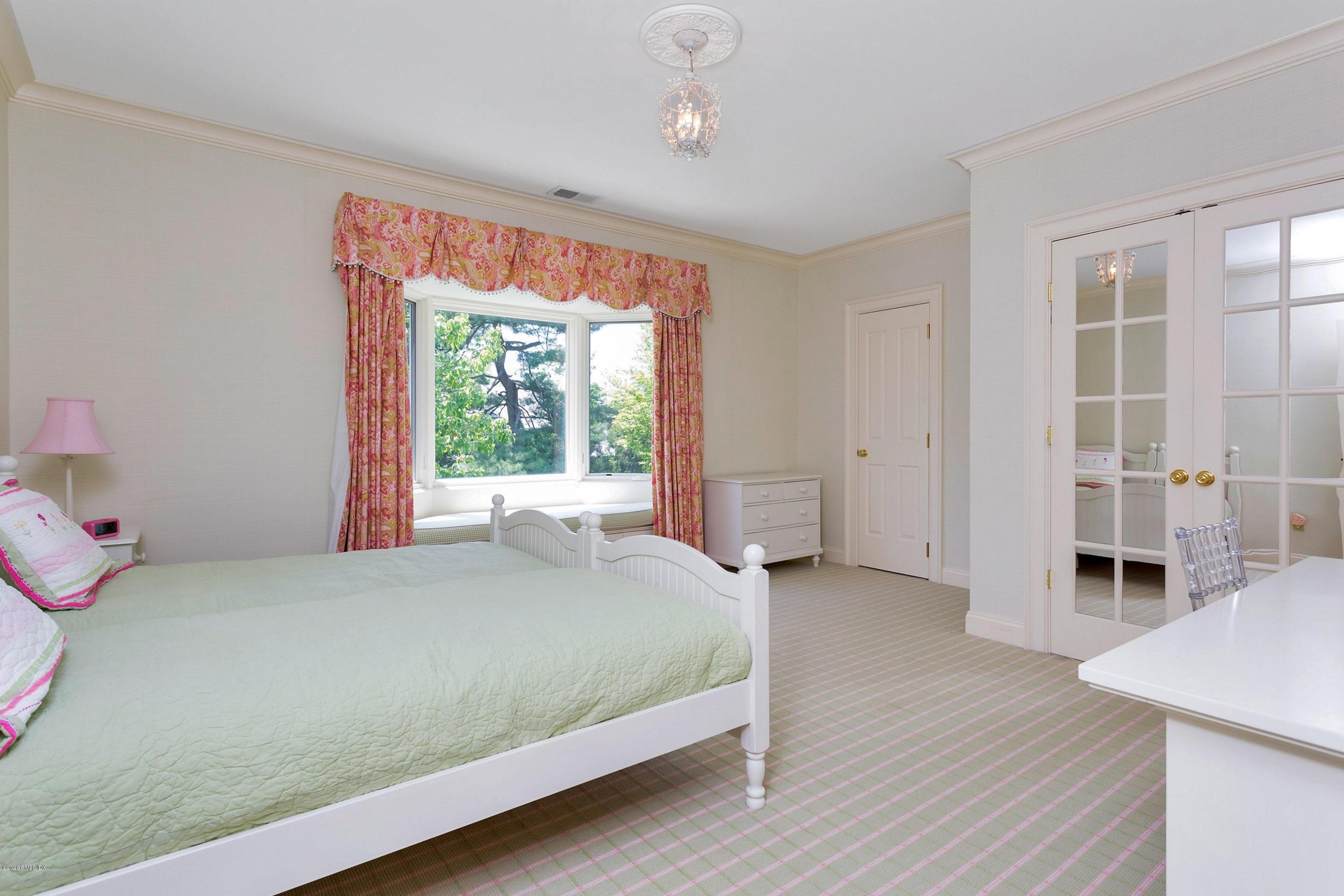 188 Otter Rock Drive Greenwich, CT 06830 - Photo 15 of 23 a bedroom with a bed and a window