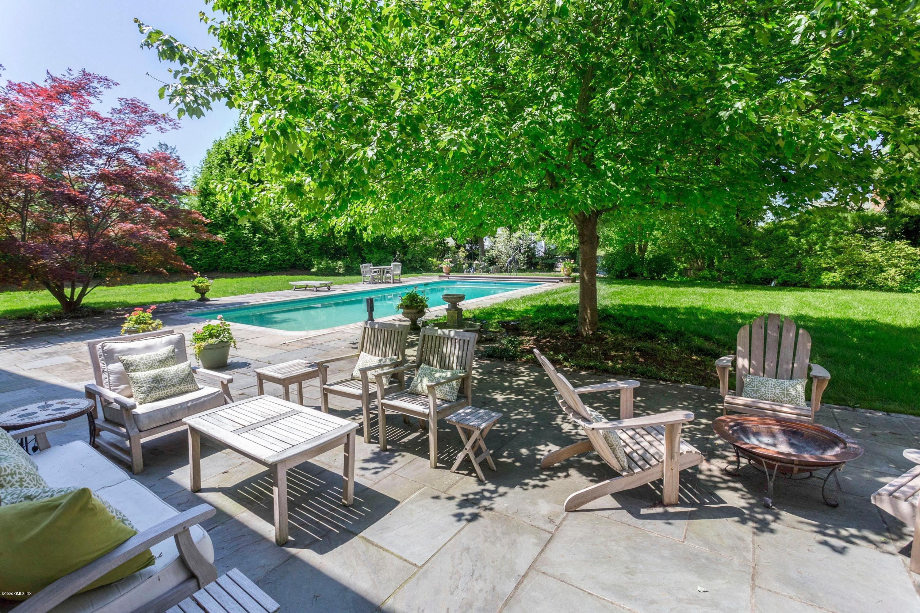 188 Otter Rock Drive Greenwich, CT 06830 - Photo 18 of 23 a view of patio with table and chairs potted plants and a large tree