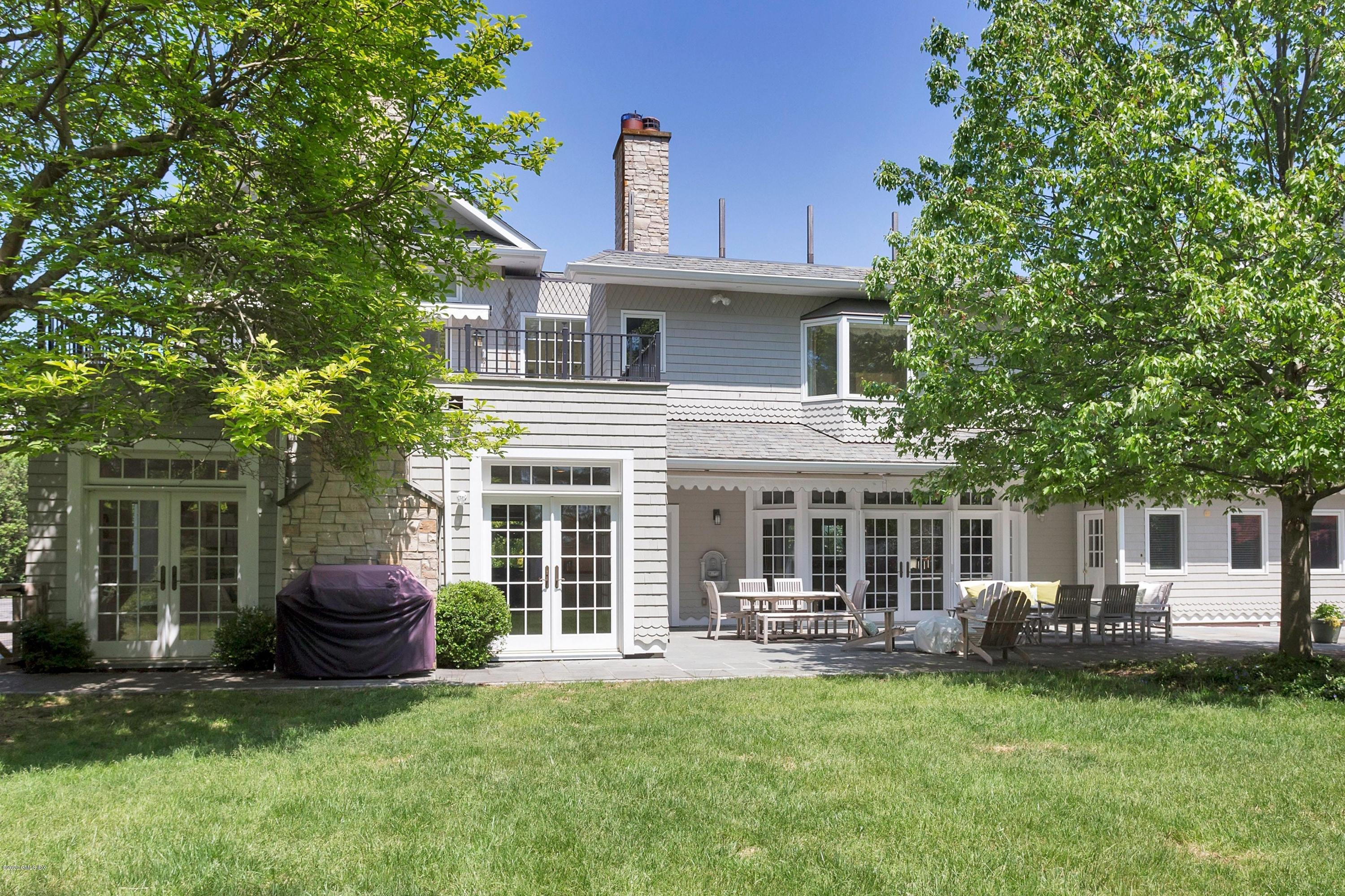 188 Otter Rock Drive Greenwich, CT 06830 - Photo 19 of 23 a front view of a house with a garden and porch