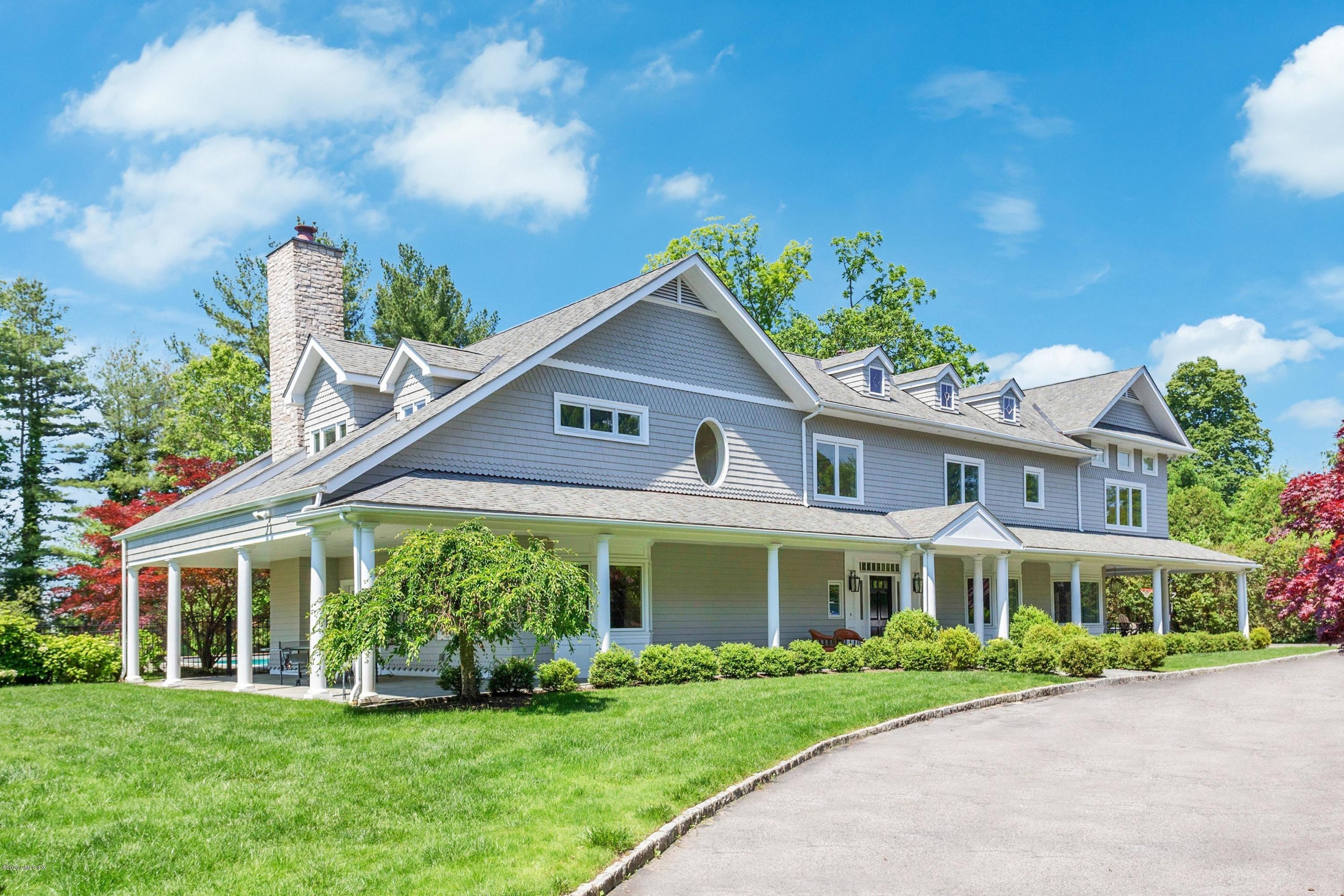 188 Otter Rock Drive Greenwich, CT 06830 - Photo 2 of 23 a front view of a house with a yard