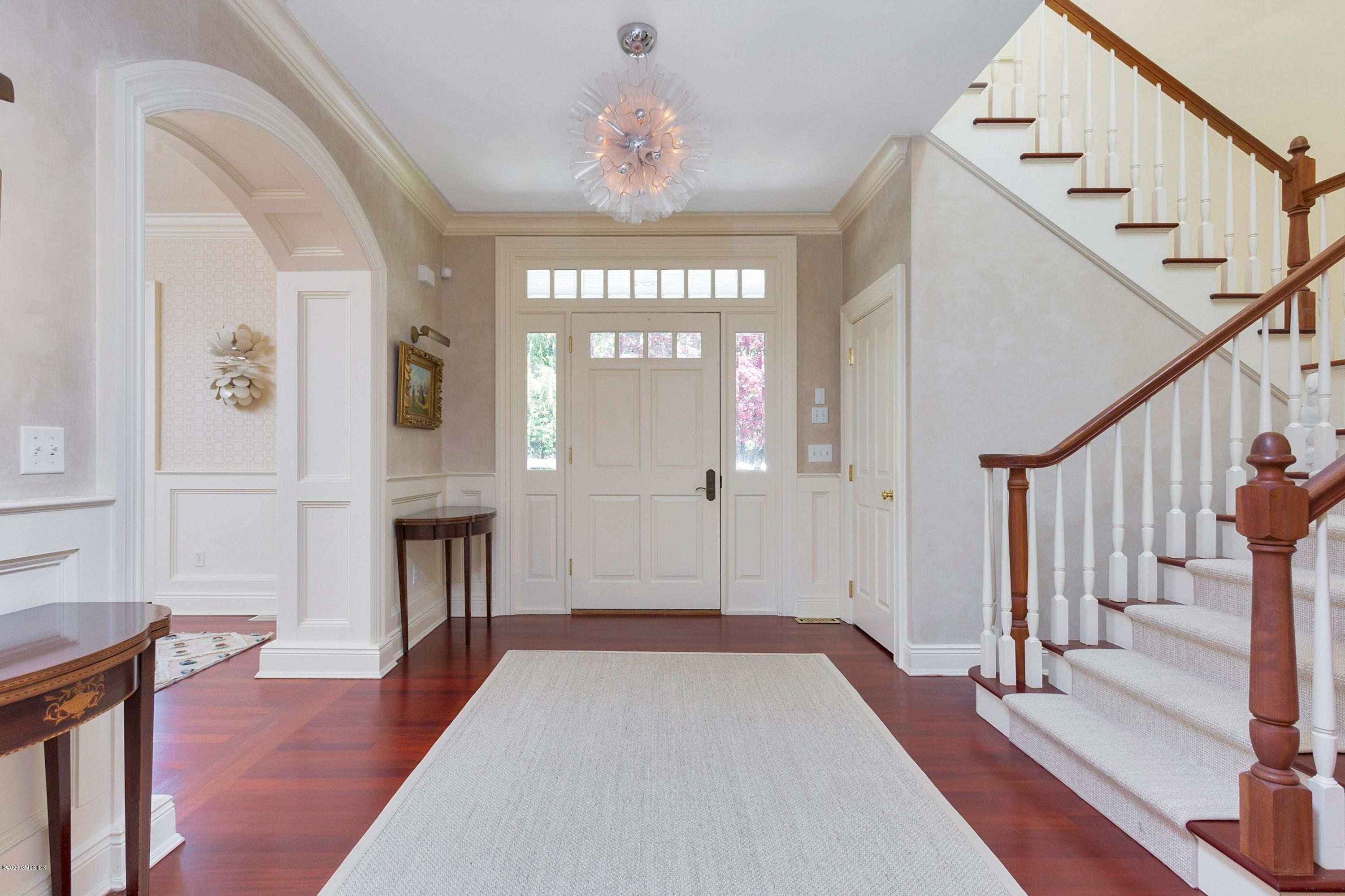 188 Otter Rock Drive Greenwich, CT 06830 - Photo 4 of 23 a view of a hallway with wooden floor and staircase