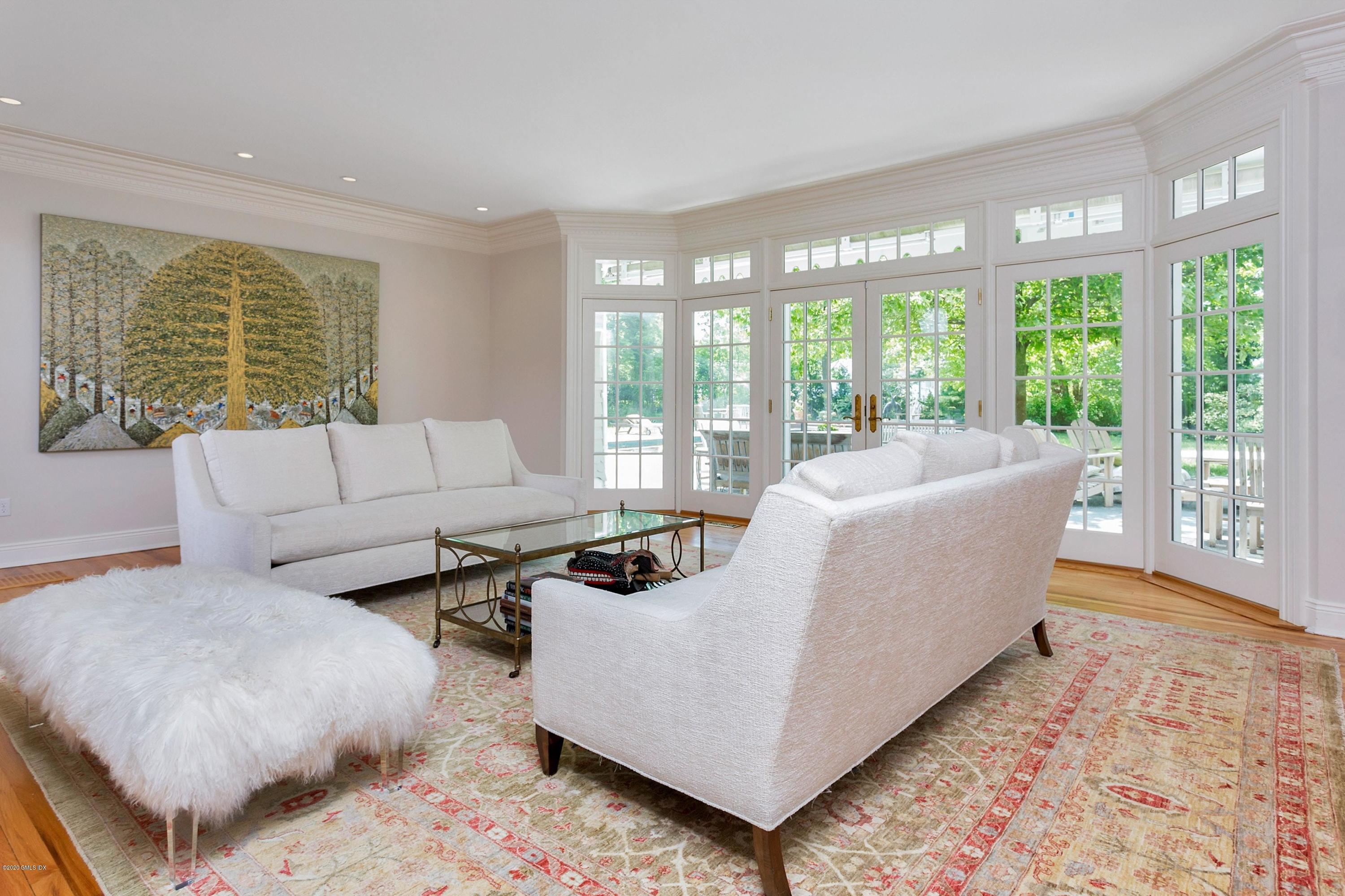 188 Otter Rock Drive Greenwich, CT 06830 - Photo 9 of 23 a living room with furniture and large windows
