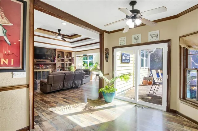 a living room with furniture a large window and a chandelier