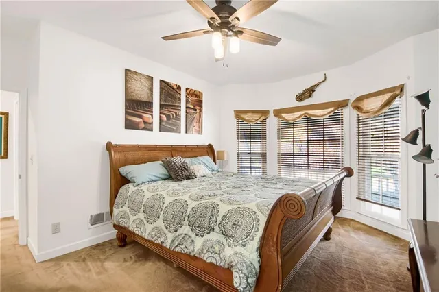 a spacious bathroom with a granite countertop sink a large mirror and a toilet