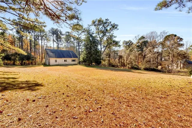 an aerial view of a house with swimming pool and outdoor space