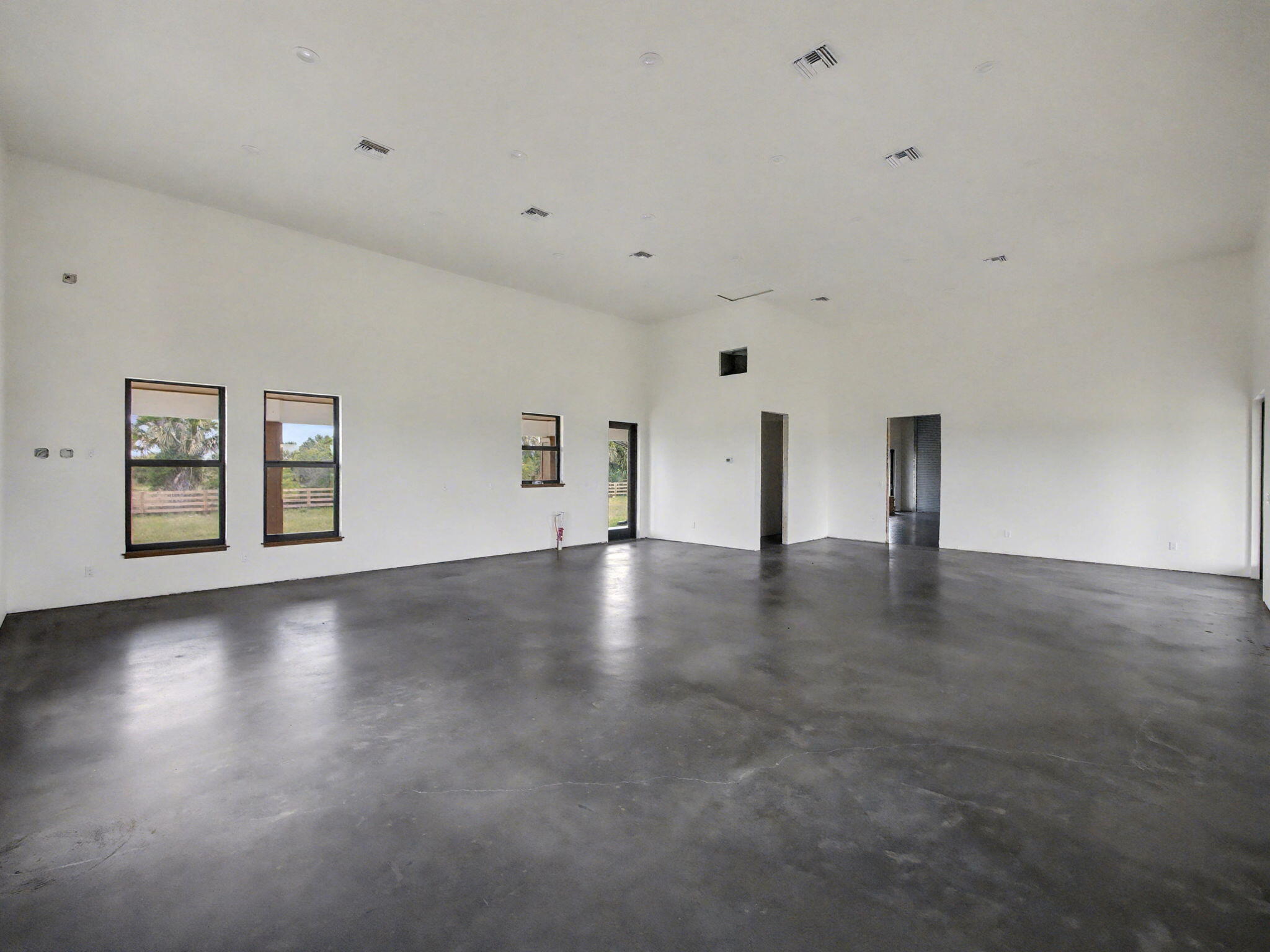 9480 Carlton Road Port St. Lucie, FL 34987 - Photo 18 of 35 a view of an empty room with window and wooden floor