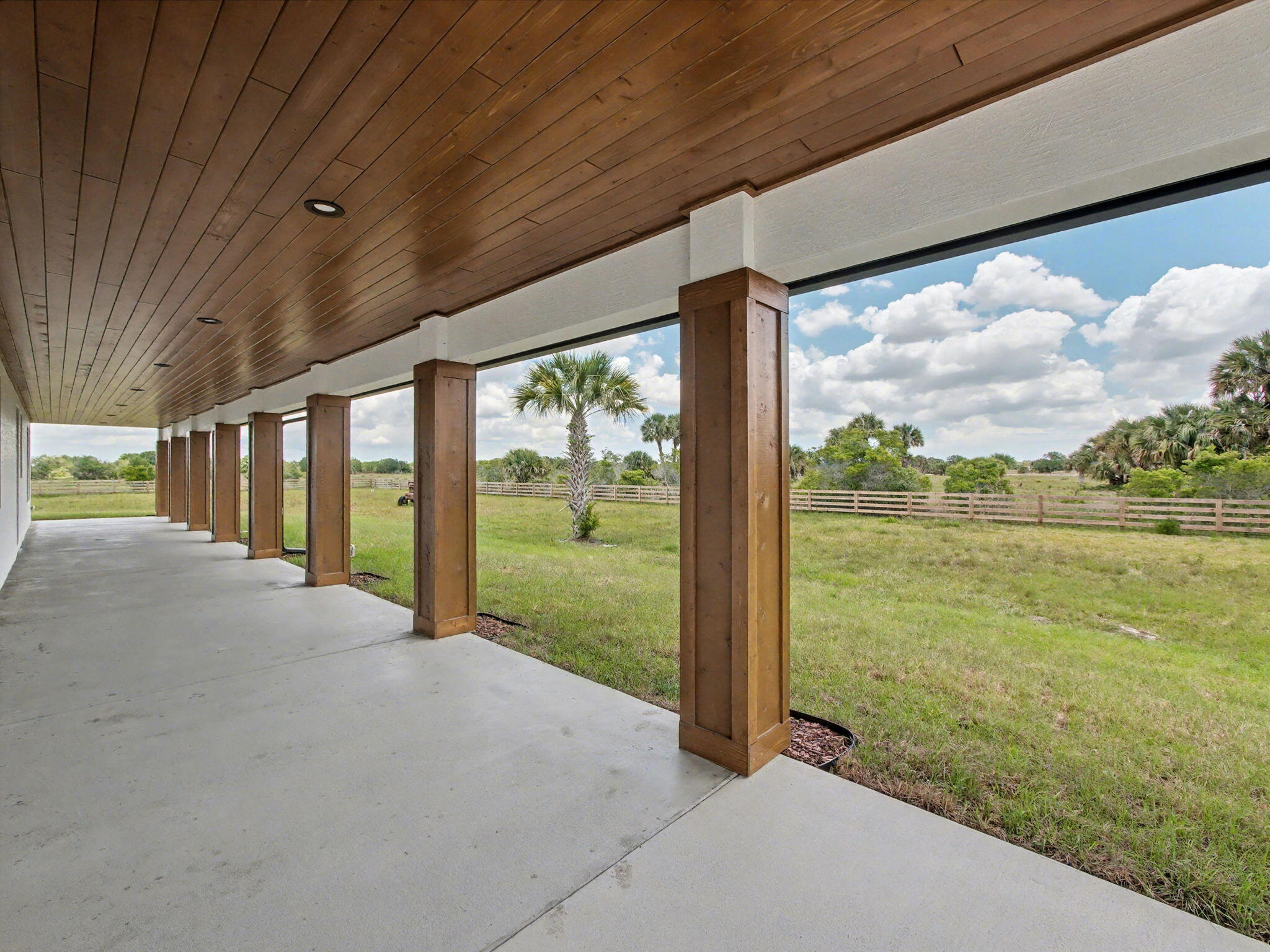 9480 Carlton Road Port St. Lucie, FL 34987 - Photo 24 of 35 a view of a room with porch and wooden floor