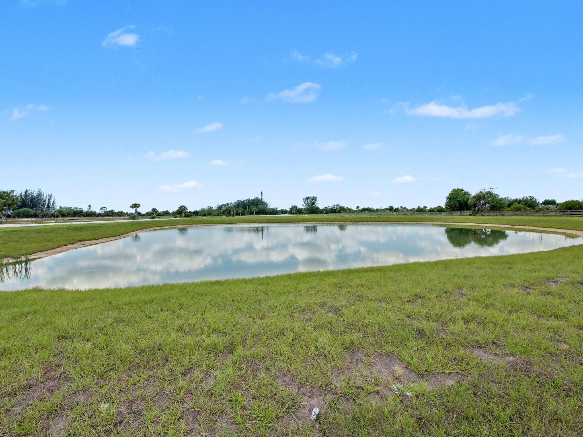 9480 Carlton Road Port St. Lucie, FL 34987 - Photo 27 of 35 a view of a lake with houses in the background