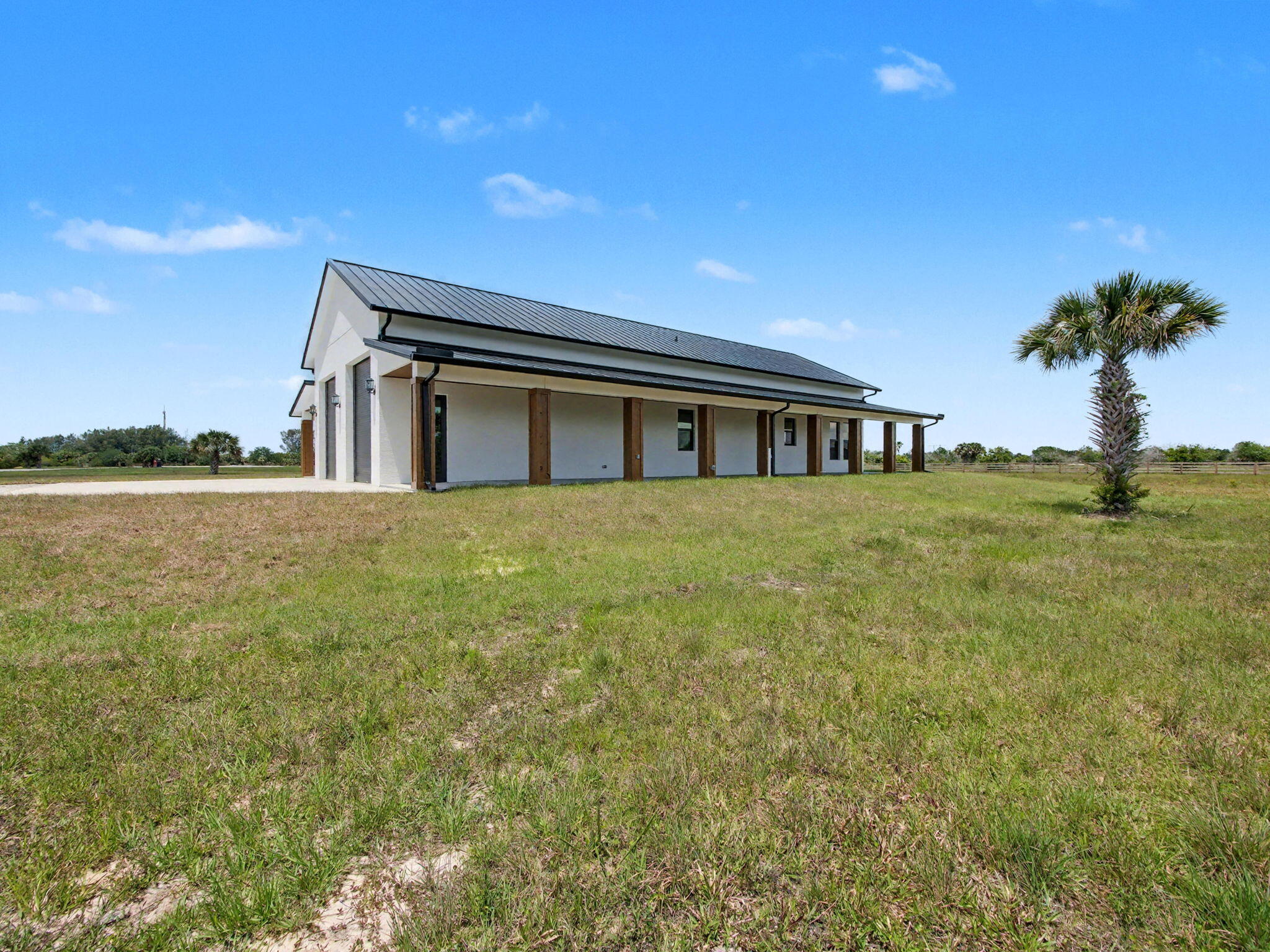 9480 Carlton Road Port St. Lucie, FL 34987 - Photo 30 of 35 a view of a house with a yard