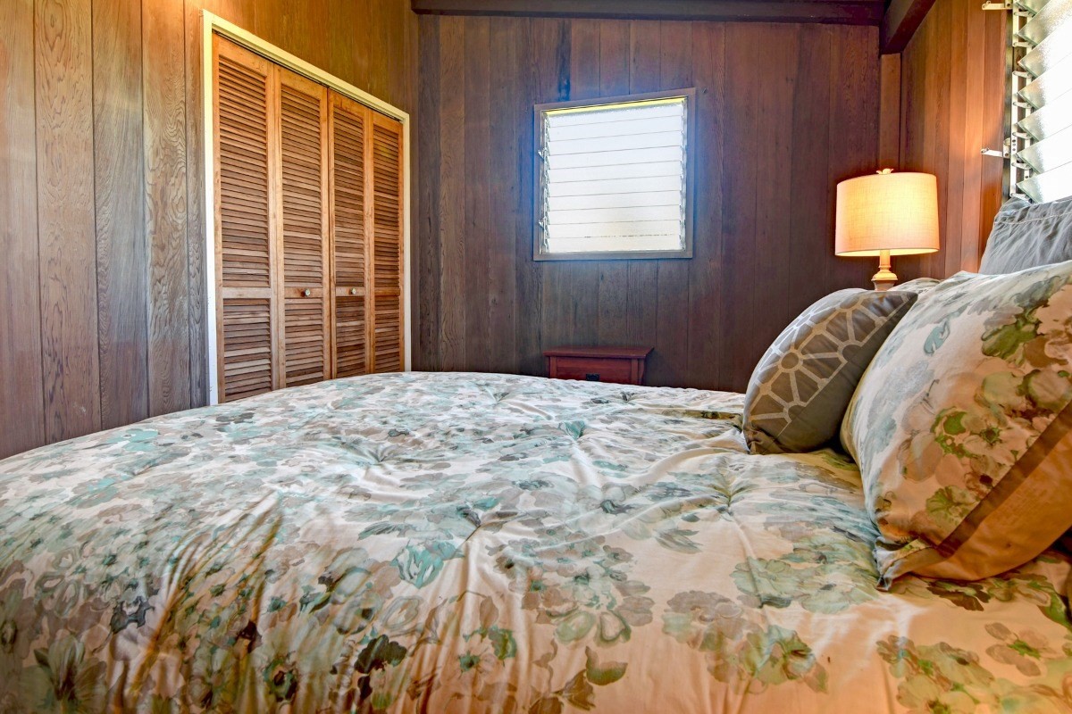 50 B Malaai Road Hilo, HI 96720 - Photo 30 of 30 a bedroom with a bed and a lamp on dresser