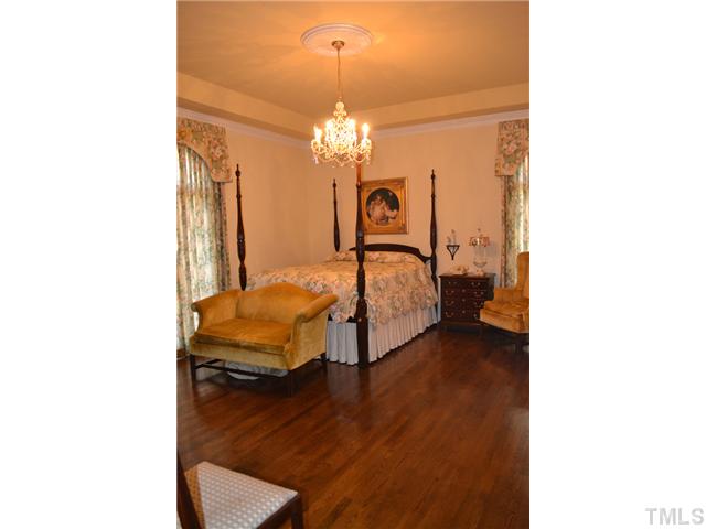 86 Dogeye Road Benson, NC 27504 - Photo 14 of 24 This master bedroom is lovely in its simple elegance. Hardwood floors, crystal chandelier, trey ceiling, space for a sitting area and an en-suite bathroom are just some features that make this master special.