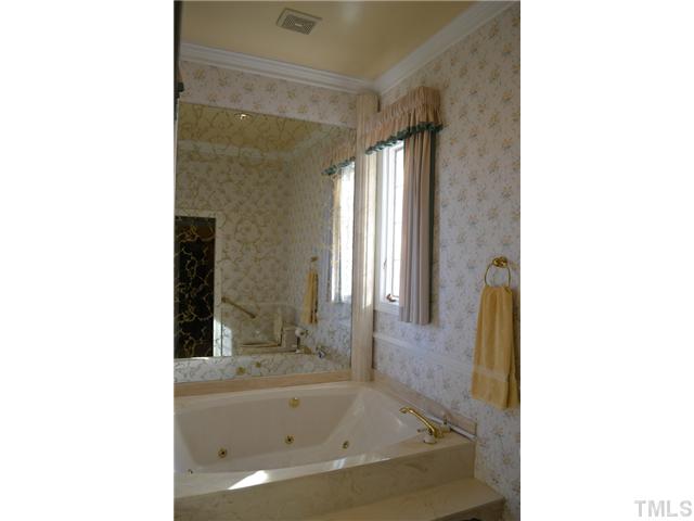 86 Dogeye Road Benson, NC 27504 - Photo 16 of 24 The 5 piece master bathroom has a two person Jacuzzi tub, separate sinks and a stand-up shower with bench.