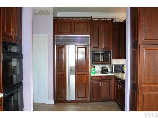 86 Dogeye Road Benson, NC 27504 - Photo 6 of 24 A Sub-Zero fridge with custom matched mahogany panels add a special touch to this large kitchen. The beautiful cabinets provide plenty of storage.