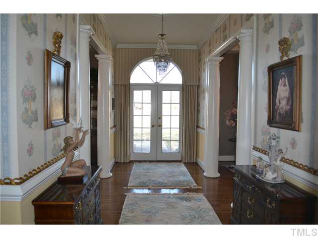 86 Dogeye Road Benson, NC 27504 - Photo 10 of 24 The foyer is welcoming in its elegance with a lovely crystal chandelier, gleaming hardwoods and stately columns. The formal living room is on the right, and the formal dining room sits to the left.