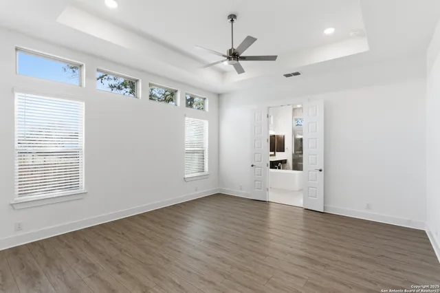 a bathroom with a bathtub sink double vanity and mirror