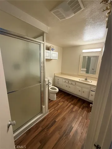a bathroom with a double vanity sink toilet and shower