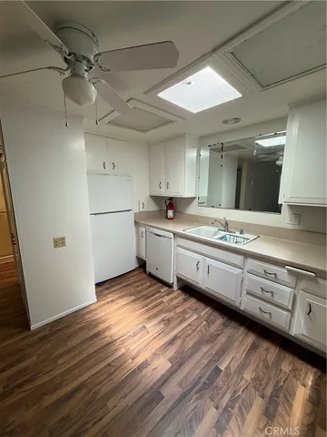 a kitchen with a sink stainless steel appliances and cabinets
