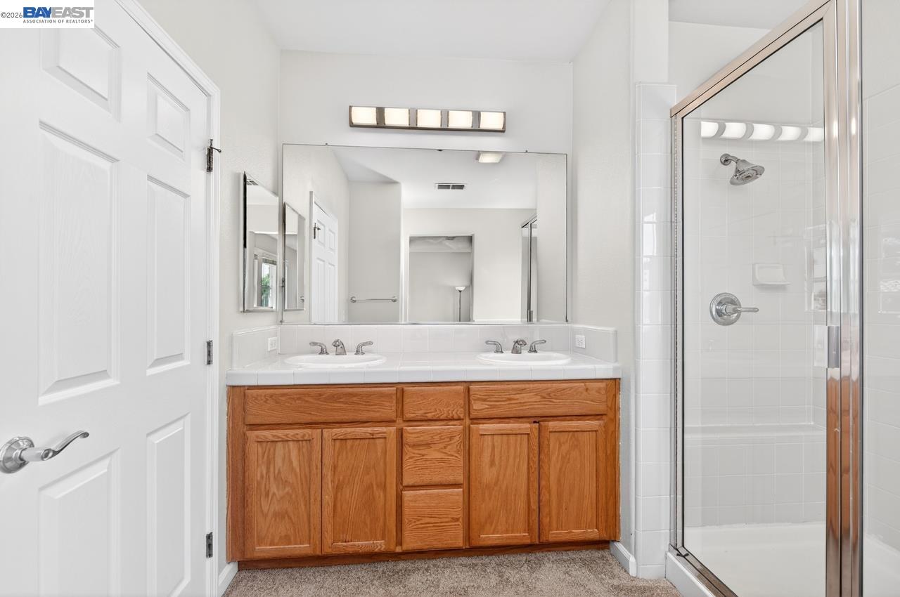 3391 Monaghan Street Dublin, CA 94568 - Photo 26 of 57 a bathroom with a double vanity sink mirror and bathtub