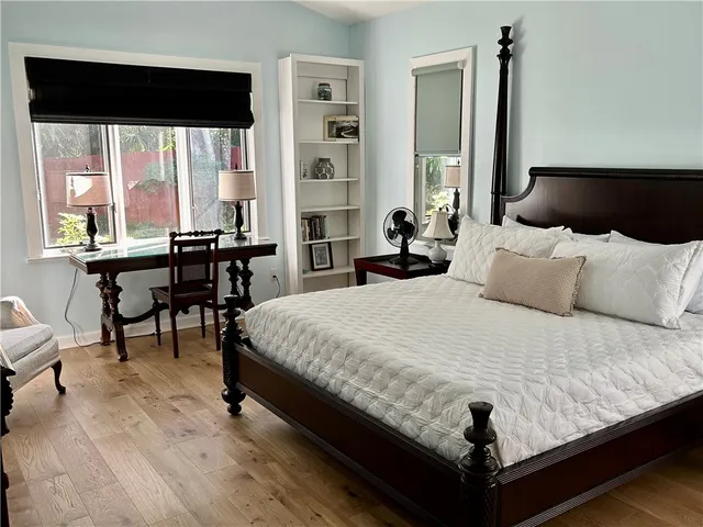 a bedroom with a bed window and a table