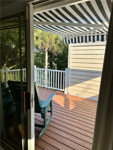 a view of a chair and table in the balcony