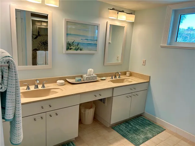 a bathroom with a granite countertop sink mirror and