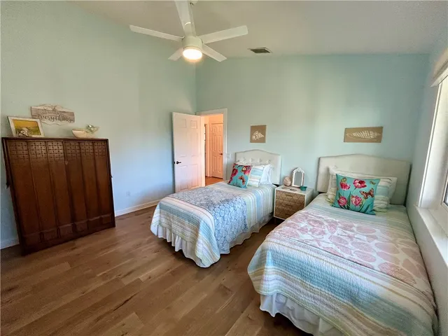 a bedroom with two beds and a closet