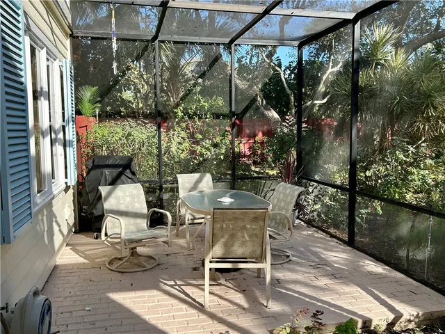 a view of balcony with chairs and table