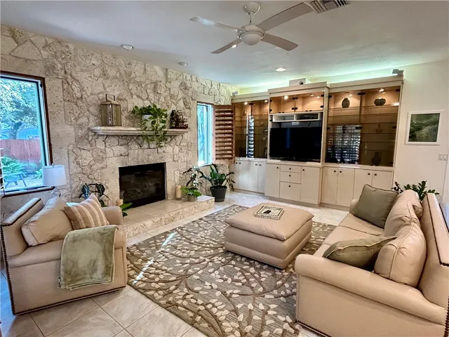 a living room with furniture and a fireplace