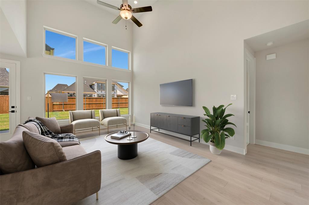 4308 Palomino Road Aubrey, TX 76227 - Photo 19 of 40 a living room with furniture and a potted plant