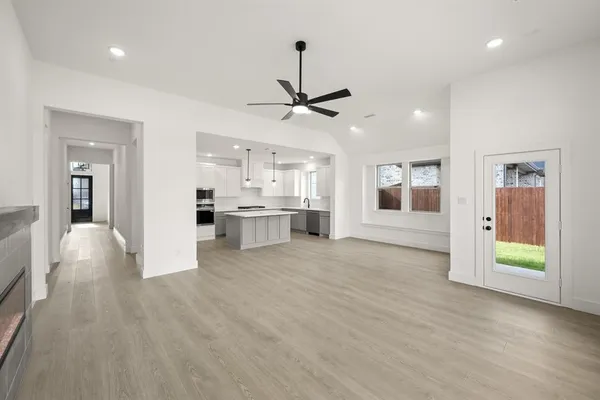 a view of a kitchen with a sink and a kitchen island