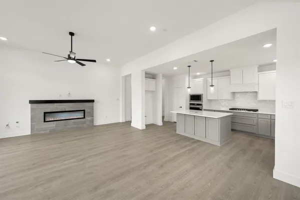 a kitchen with kitchen island white cabinets and stainless steel appliances