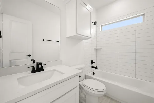 a bathroom with a sink a toilet and a bathtub