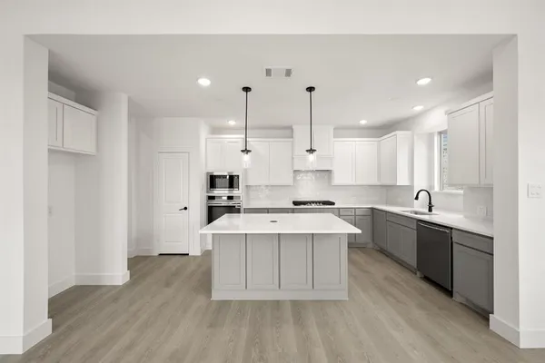 a large kitchen with a lot of counter space and a sink