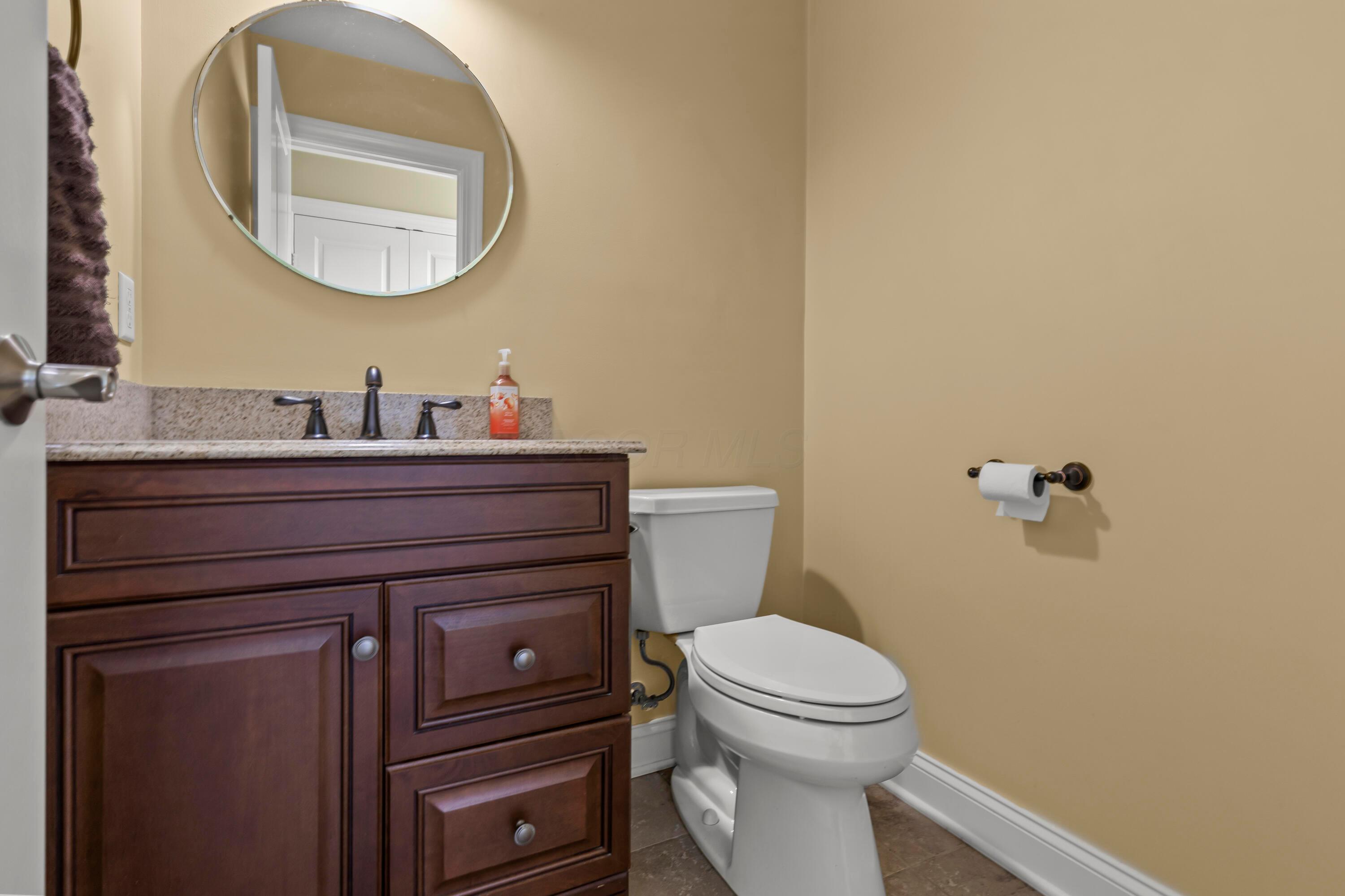 3582 Panhandle Road Delaware, OH 43015 - Photo 36 of 65 • Ceramic tile flooring • Tan painted walls • Enclosed vanity with single bowl, granite sinktop • Ceiling exhaust • 3 bulb wall light