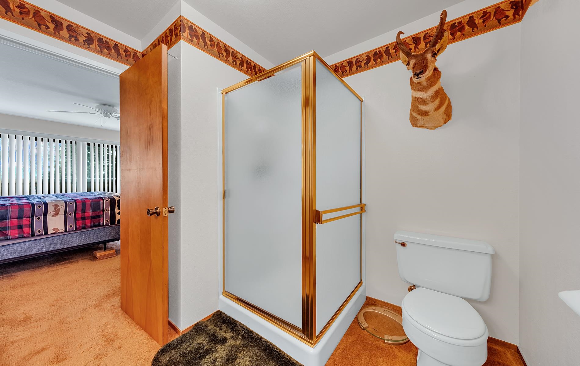 608 East Burnt Cedar Road Lake Almanor, CA 96137 - Photo 24 of 36 a bathroom with a toilet and a shower curtain