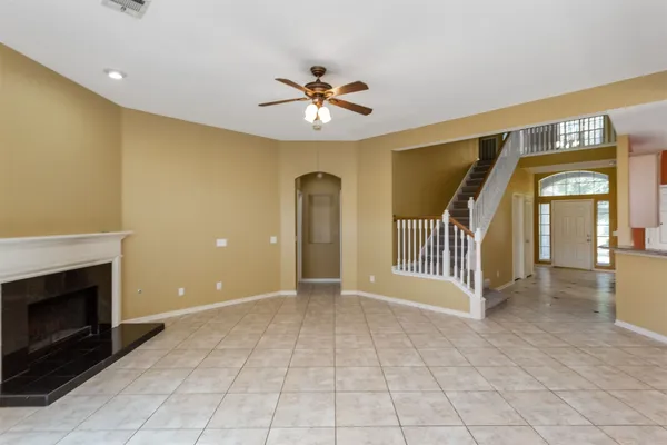 a view of an empty room with a fireplace and a window